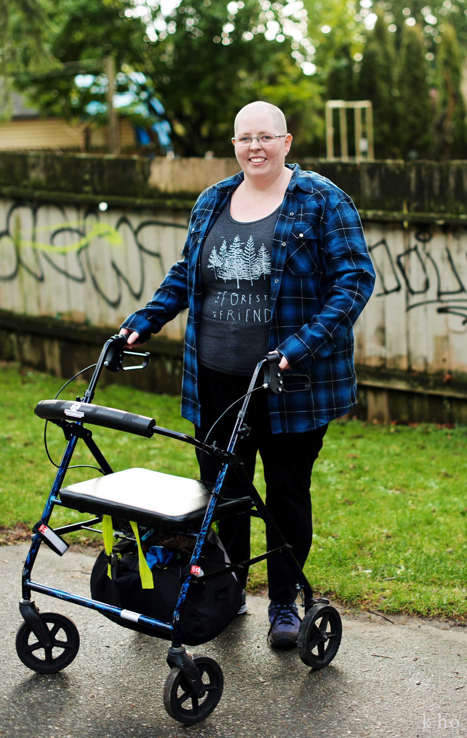 Workshop facilitator Heather McCain, outside with their walker.