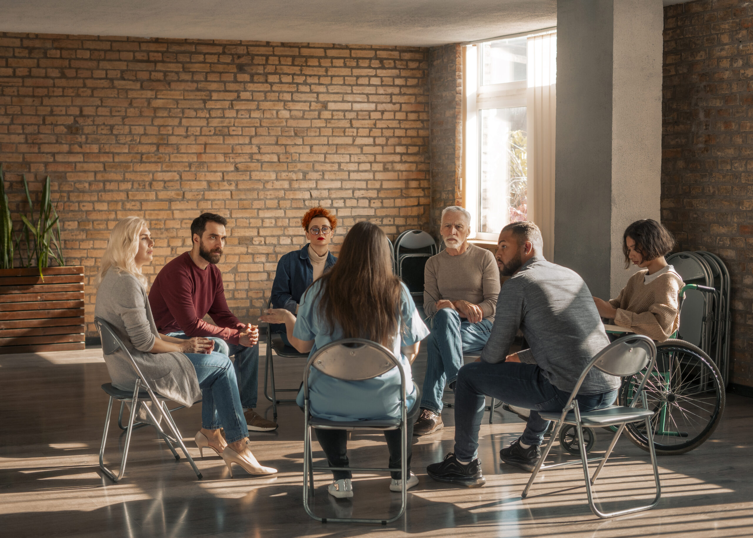 A support group in a bricked room.