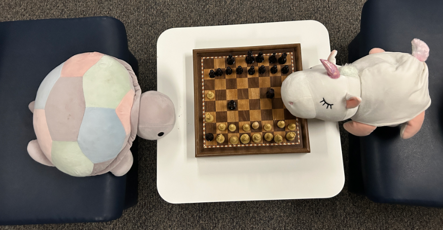 (2 stuffies playing chess.)