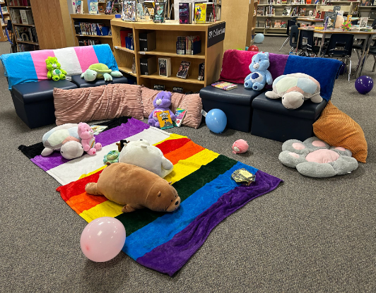 A seating area, with stuffies, in the low sensory space.